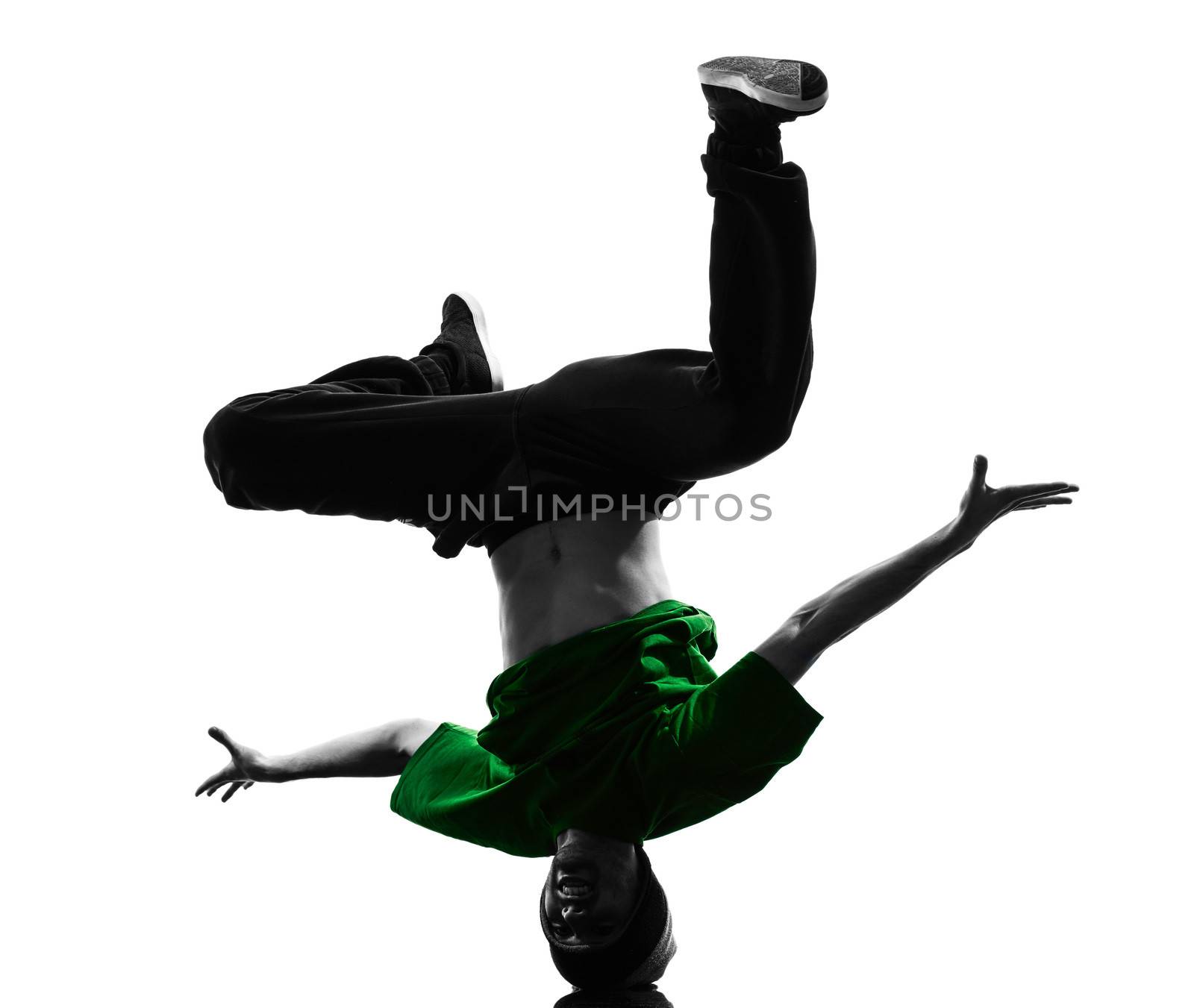 one caucasian young acrobatic break dancer breakdancing man in silhouette  white background