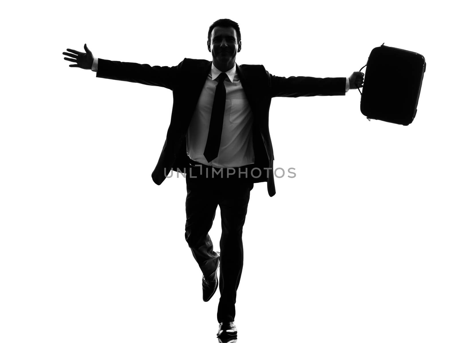 one caucasian business man running happy arms outstretched in silhouette  on white background