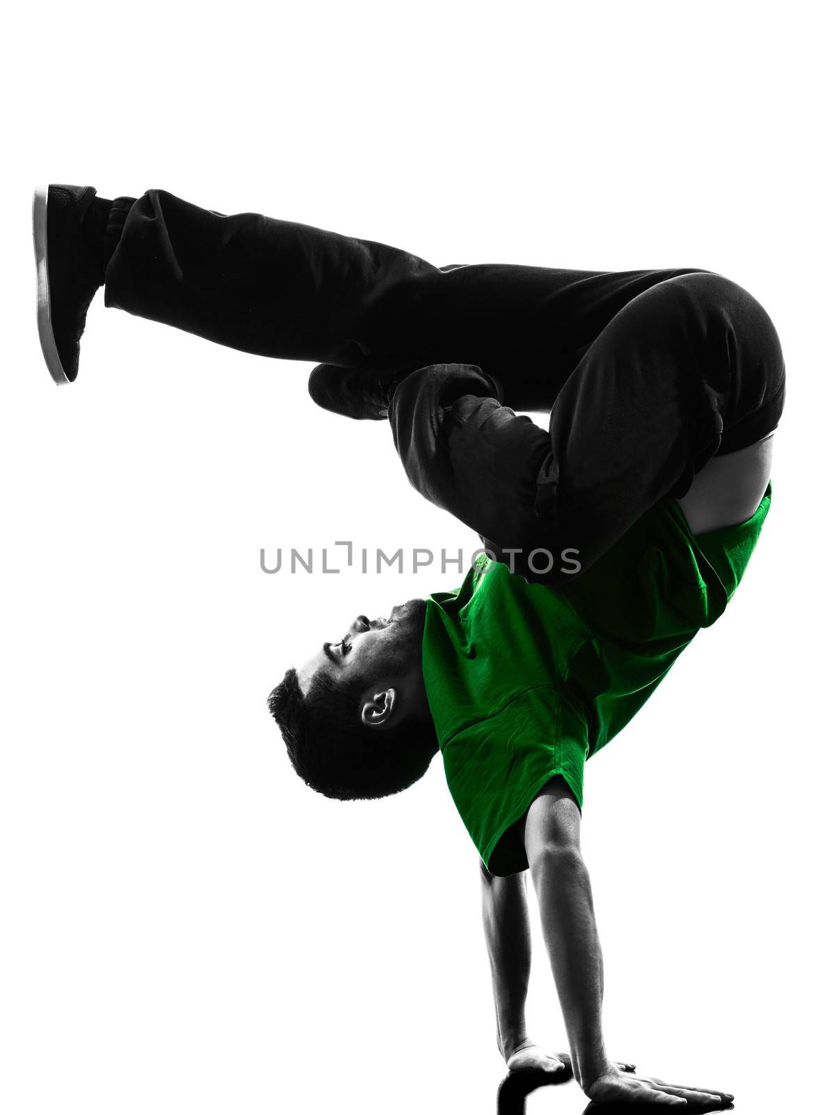 one caucasian young acrobatic break dancer breakdancing man in silhouette  white background