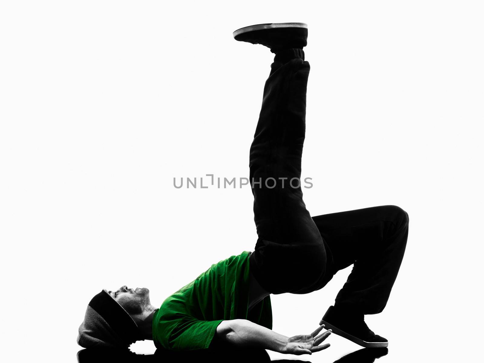 one caucasian young acrobatic break dancer breakdancing man in silhouette  white background