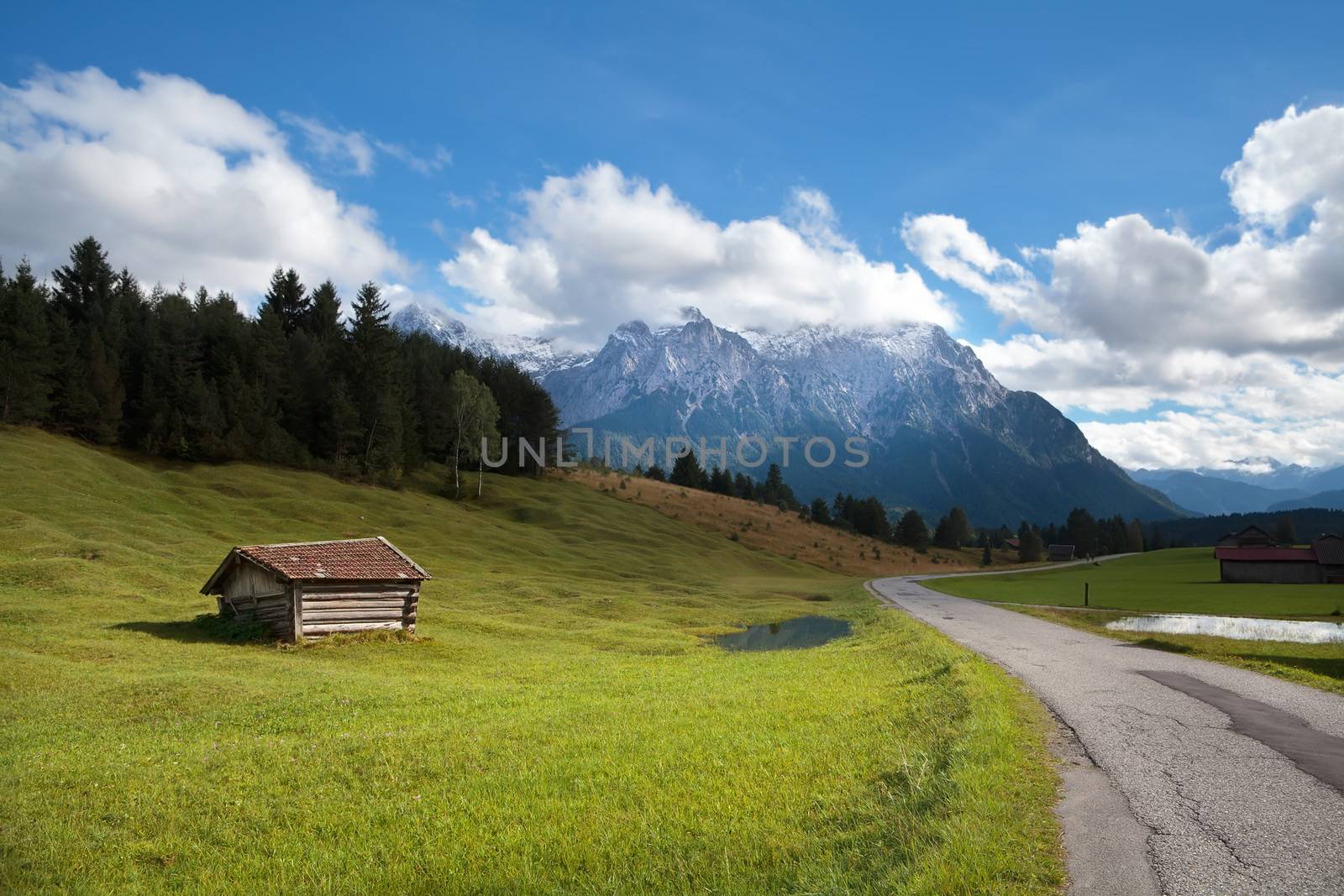 wooden hut on meadow and high Bavarian alps, Germany