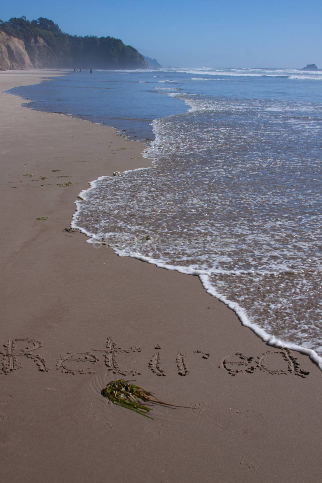 A beautiful image of a beach with the word "retired" written in the sand.