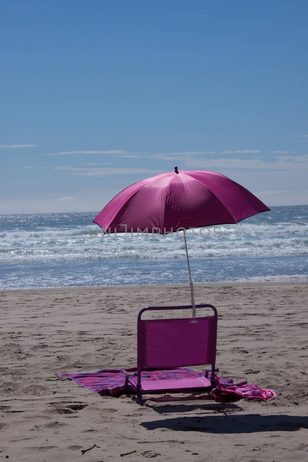 Time to relax on the beach in this beach chair and umbrella.