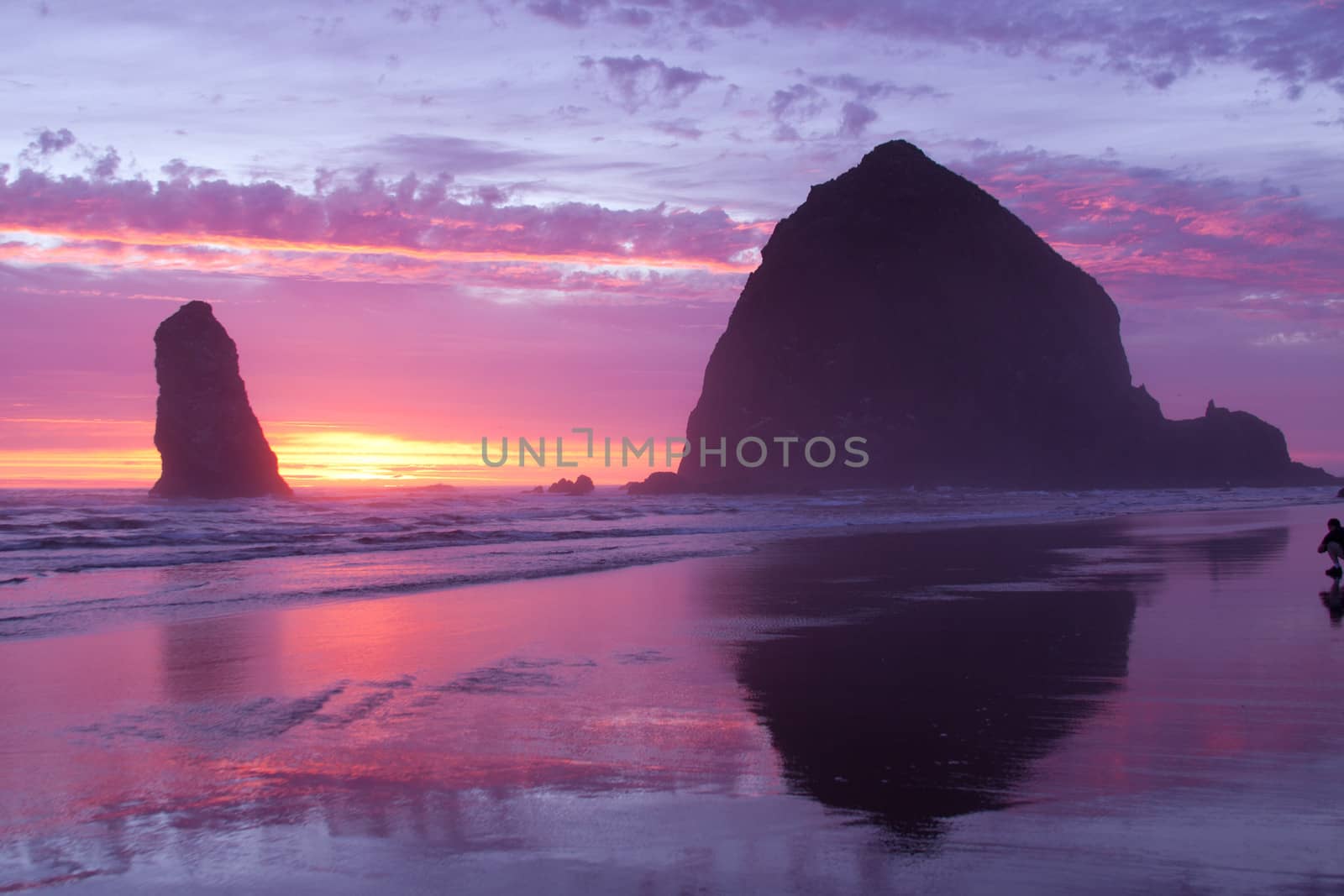 Haystack rock on Cannon Beach at sunset.  This is a major tourist attraction on the Oregon Coast, in the USA.