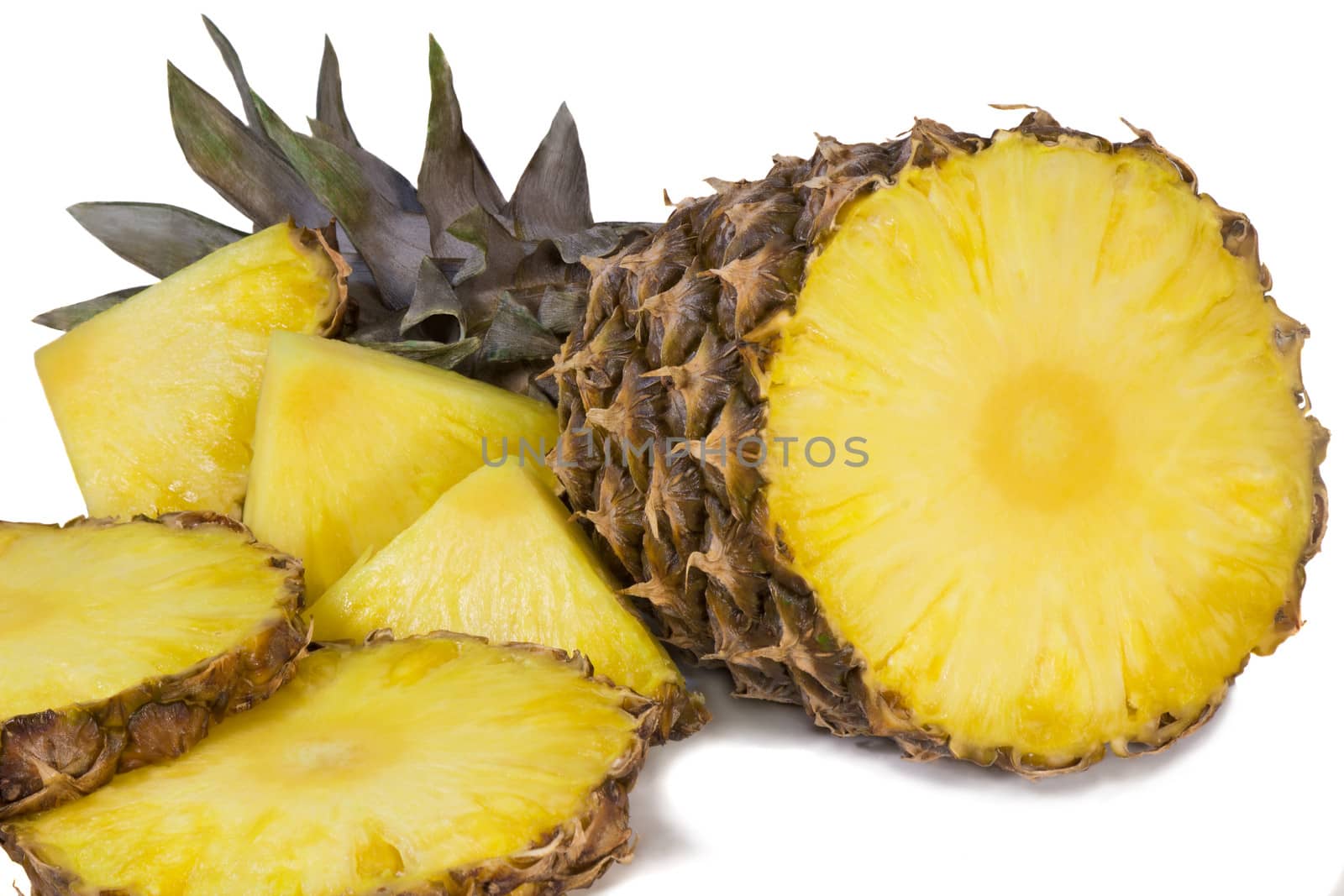 Sliced pineapple and slices of pineapple. Photographed on a white background.