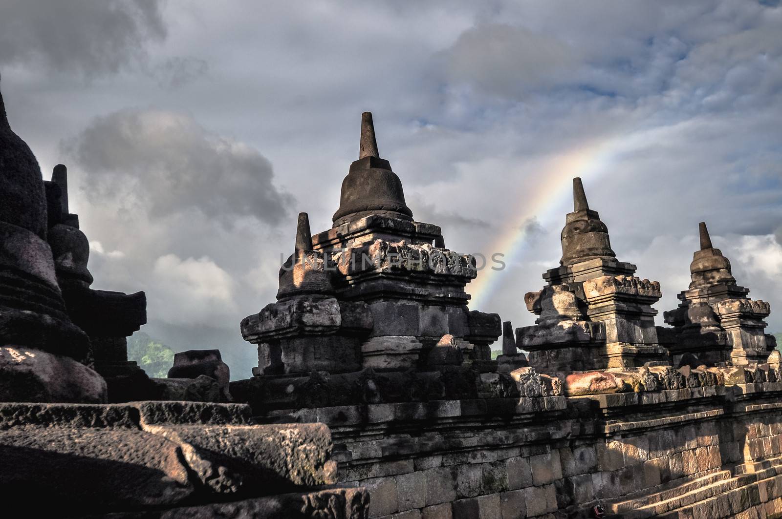 Clouds and Rainbow Buddist temple Borobudur complex in Yogjakart by weltreisendertj