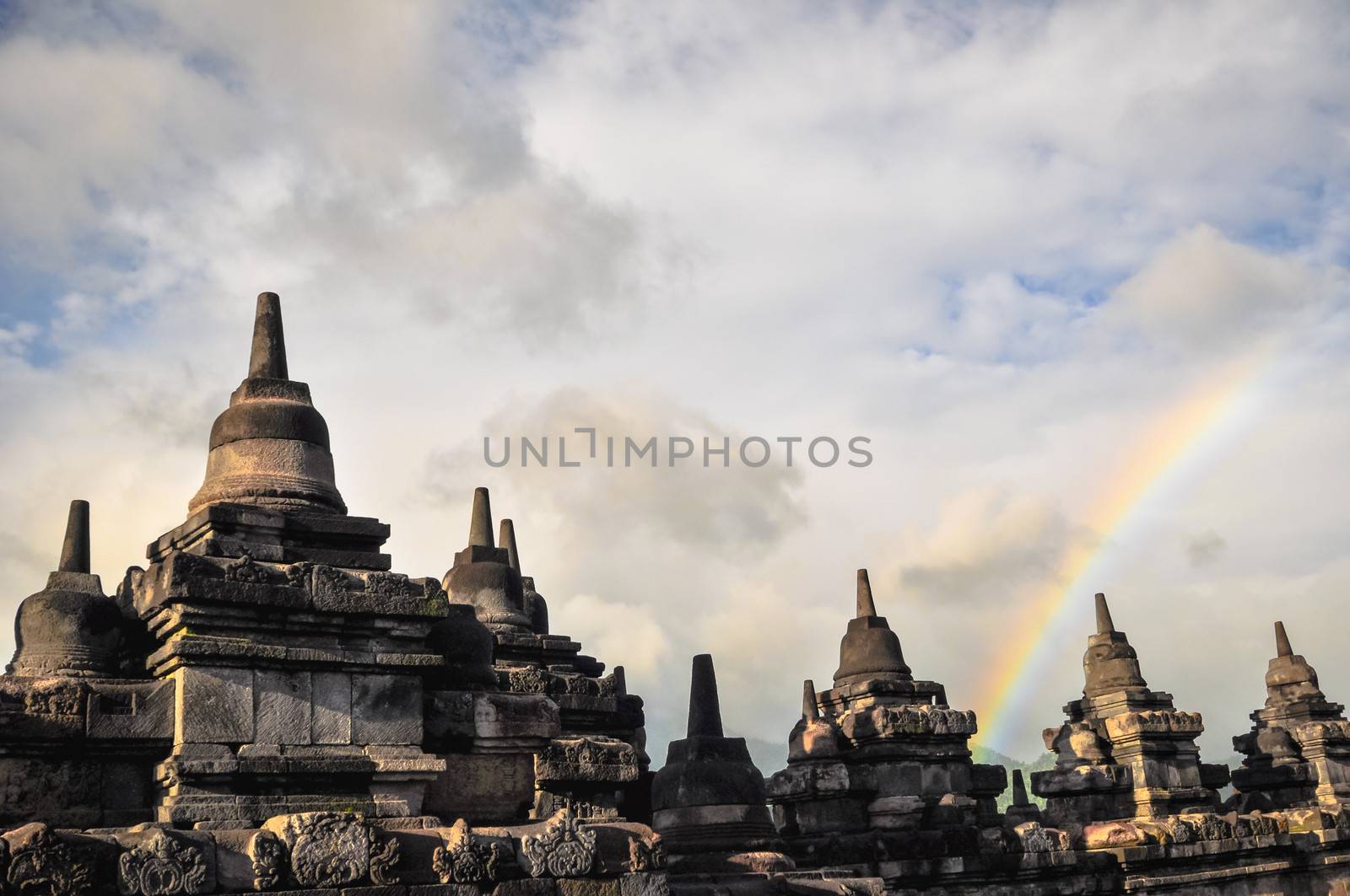 Rainbow over Stupa Buddist temple Borobudur complex in Yogjakarta in Java, indonesia