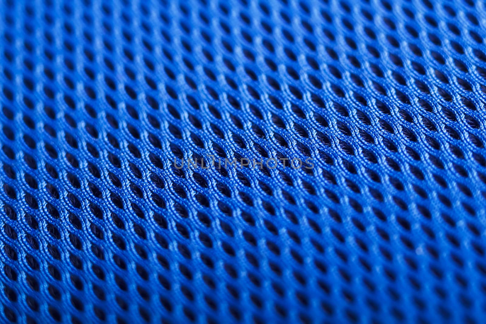 Blue background. Mesh fabric texture. Macro perspective