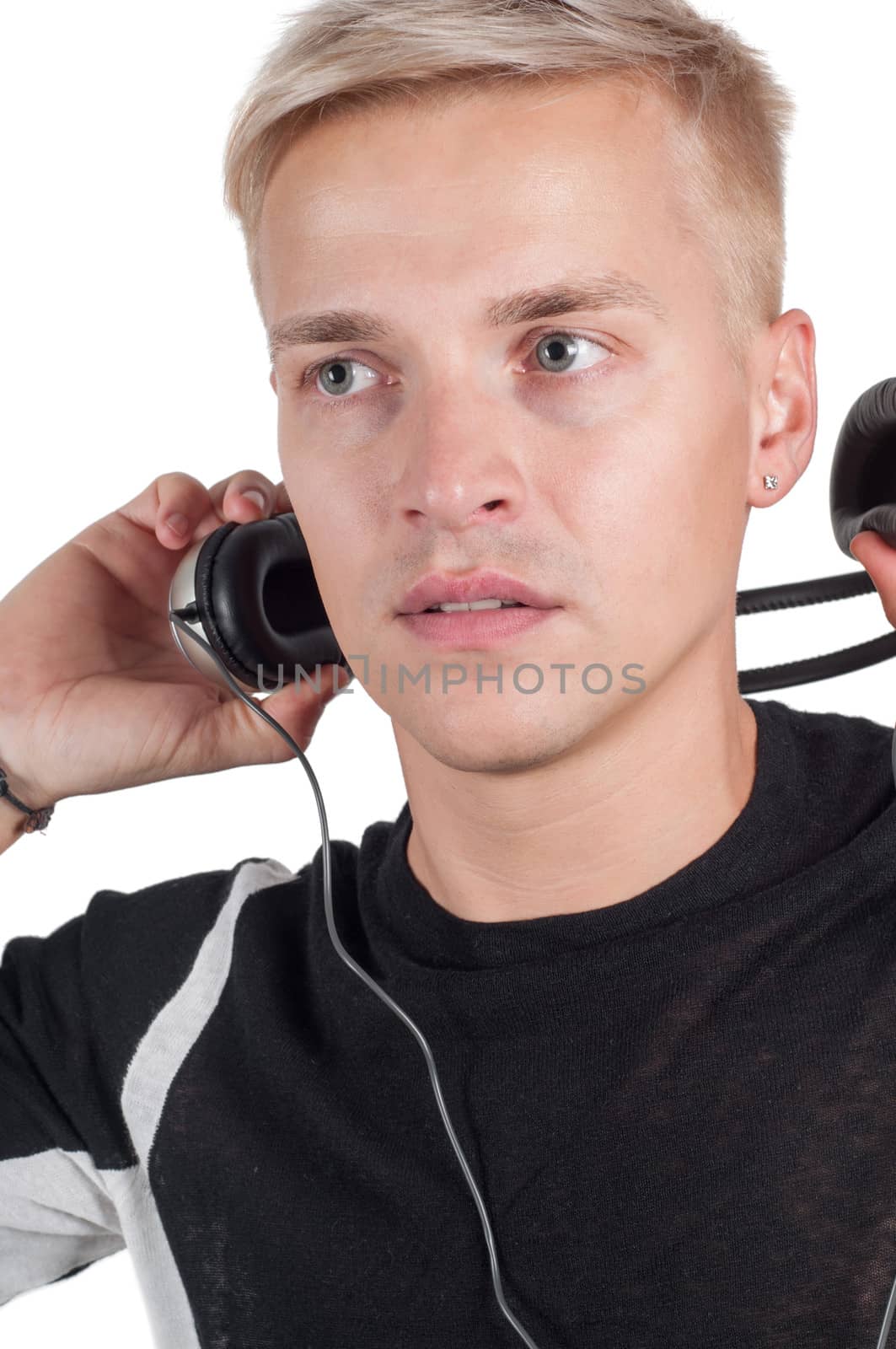 Male taking off headphones by anytka