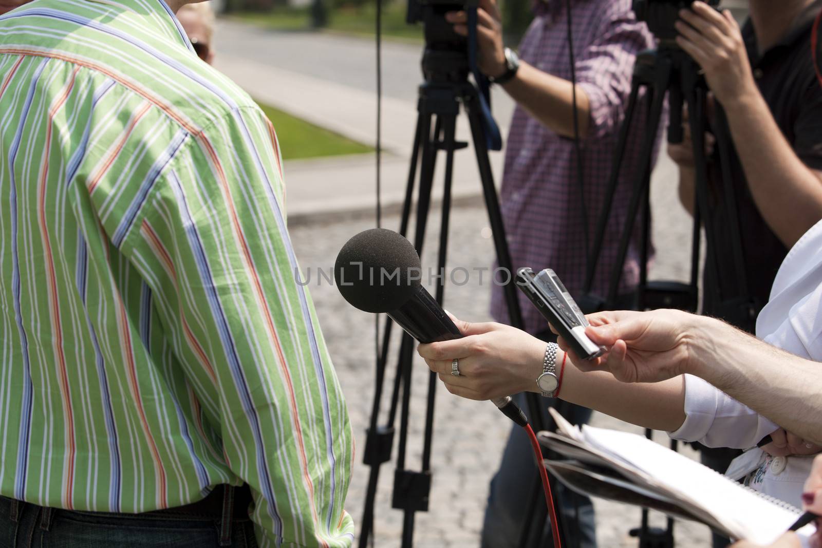 Interview with media microphone held in front of business man, spokesman or politician