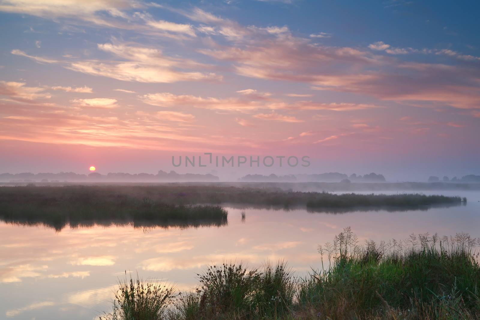 dramatic misty sunrise over river, Drenthe, Netherlands