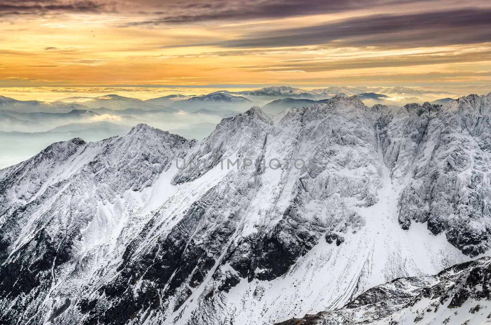 Scenic view of snowy winter mountains with colorful sunset, High Tatras, Slovakia