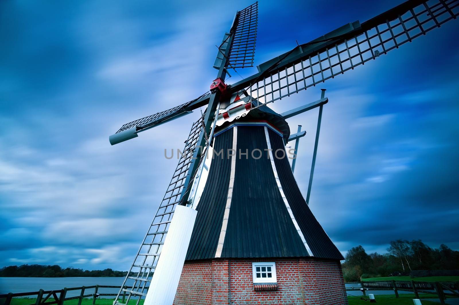 Dutch windmill over blurred sky with long exposure, Holland