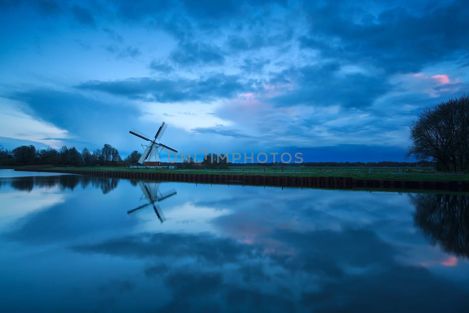 beautiful cloudscape over windmill and river, Holland