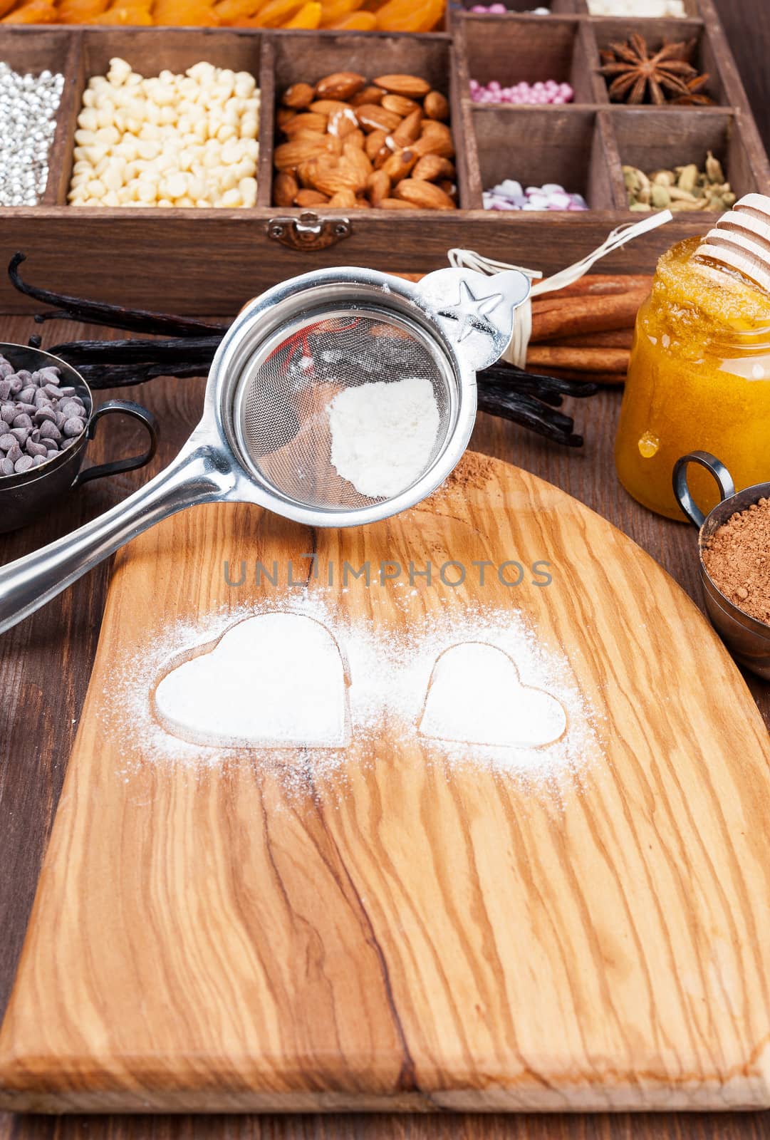 Traces in the form of heart on the background of powdered sugar