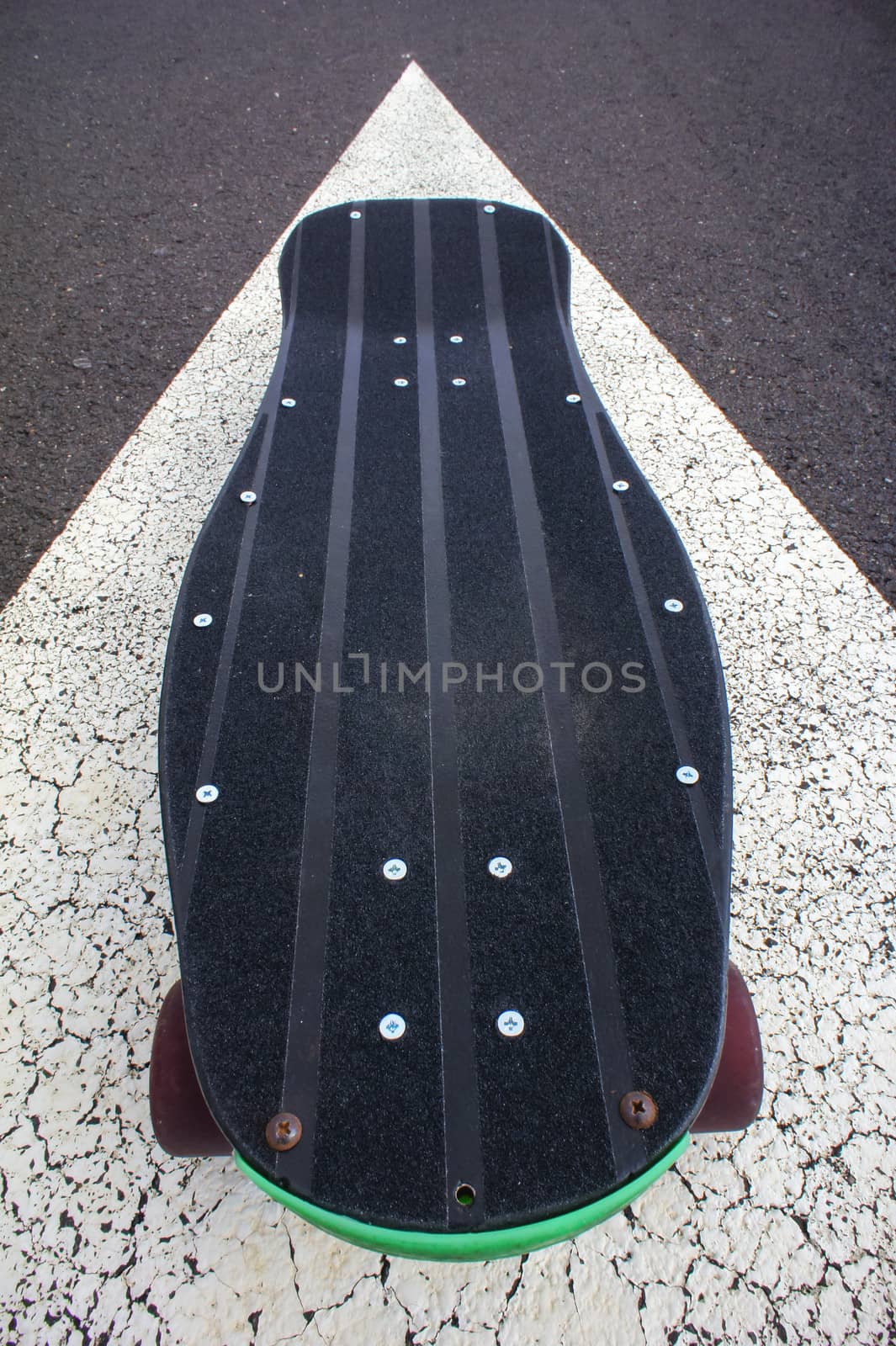 Vintage Style Longboard Black Skateboard on an Empty Asphalt Desert Road