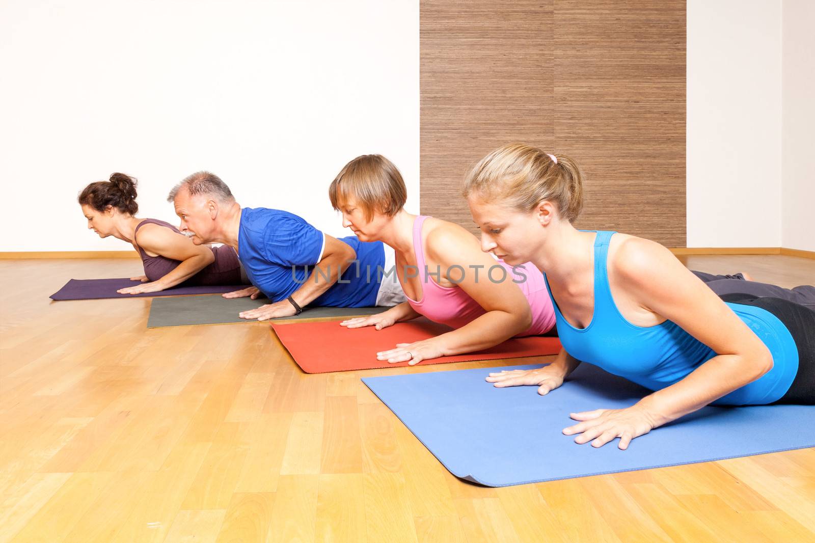 An image of some people doing yoga exercises