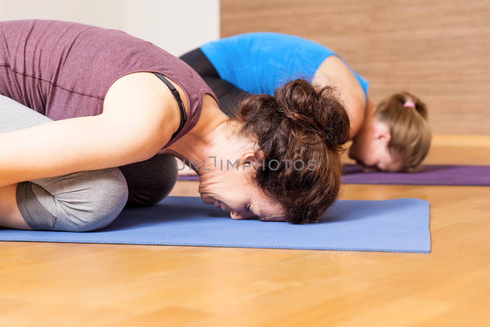 An image of some people doing yoga exercises