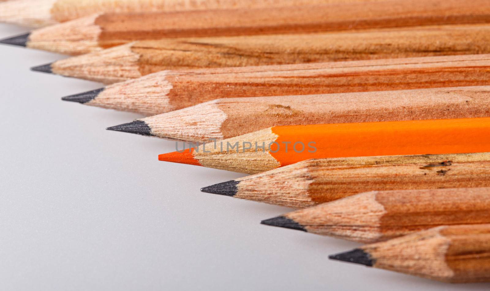 Color pencil stands out against a series of graphite pencils