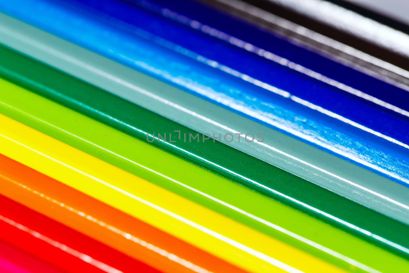 Brightly colored wooden pencils closeup shot background