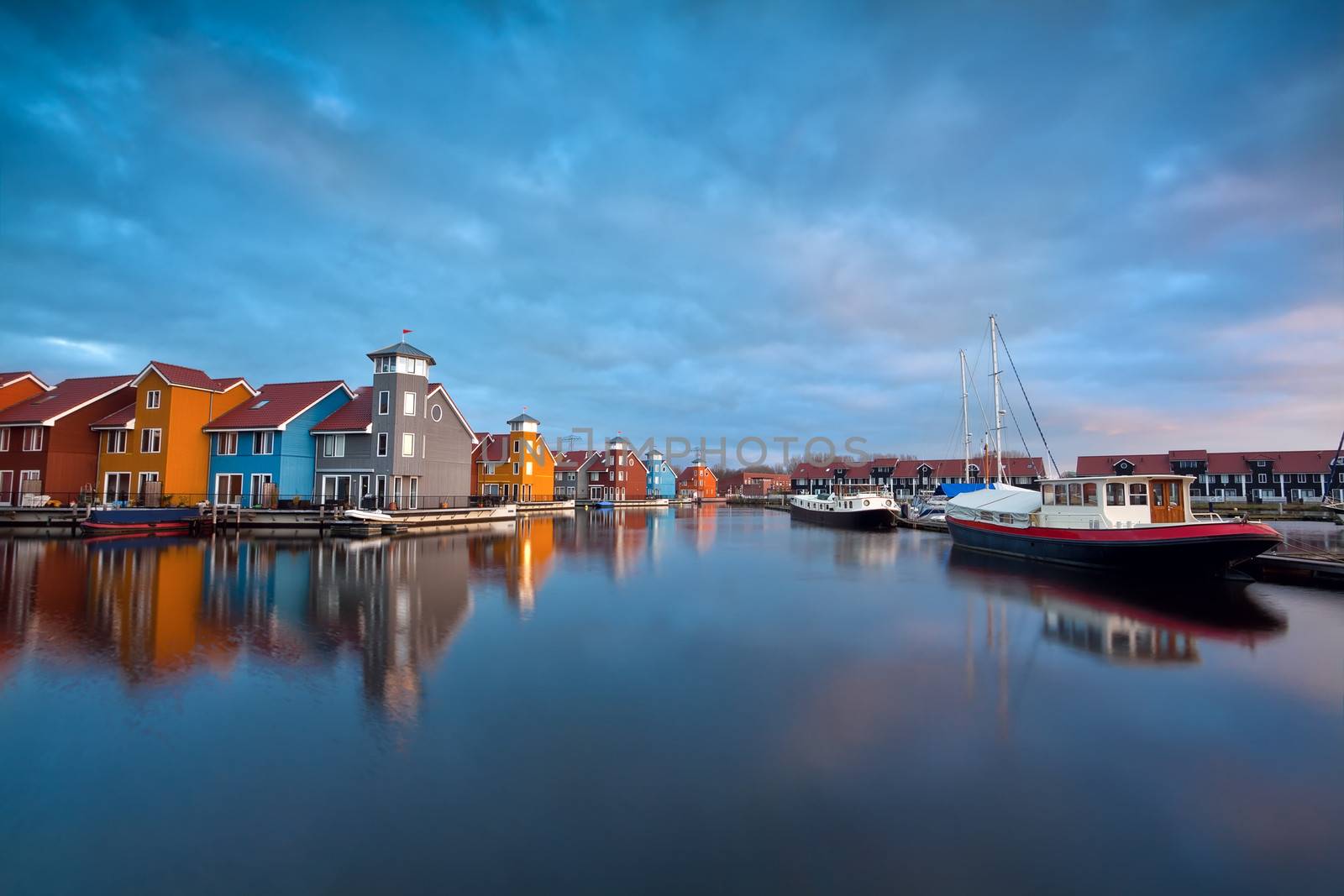 sunrise over colorful buildings and boats at Reitdiephaven, Groningen, Netherlands