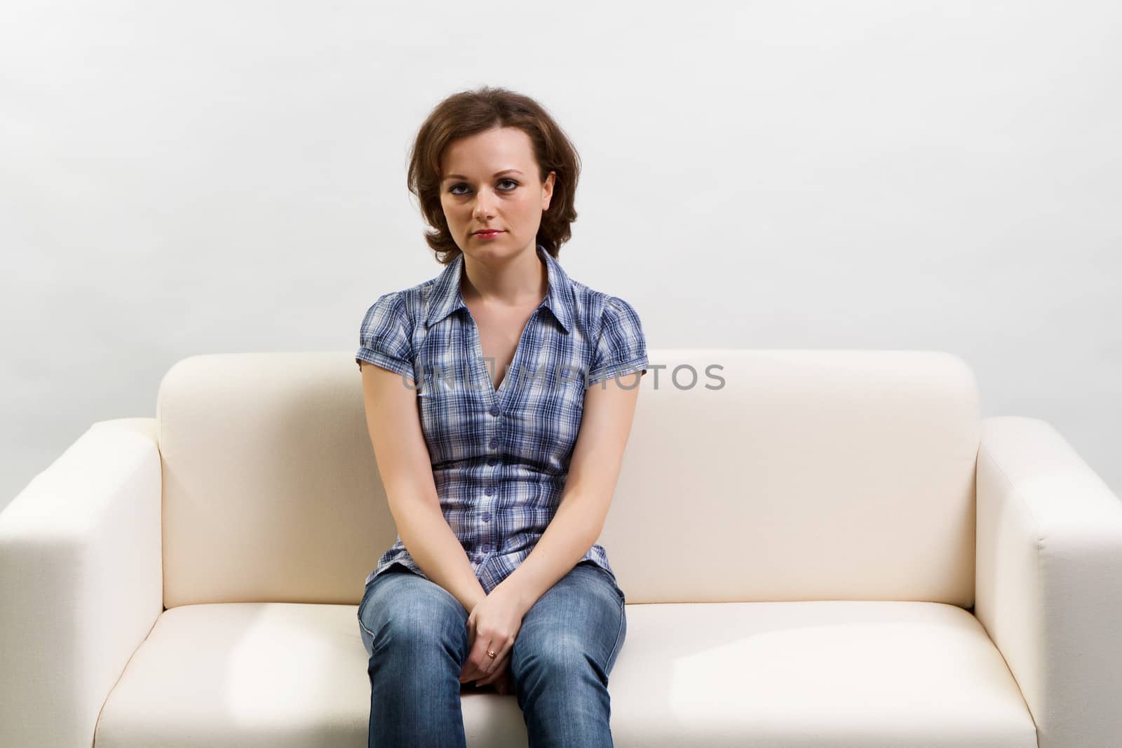 girl in a blue checkered shirt sitting on the couch