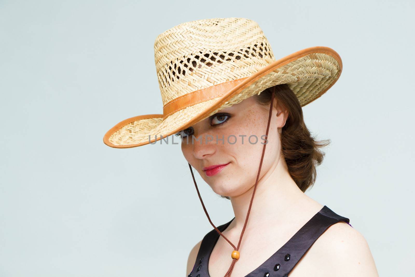 attractive girl in a straw hat. portrait