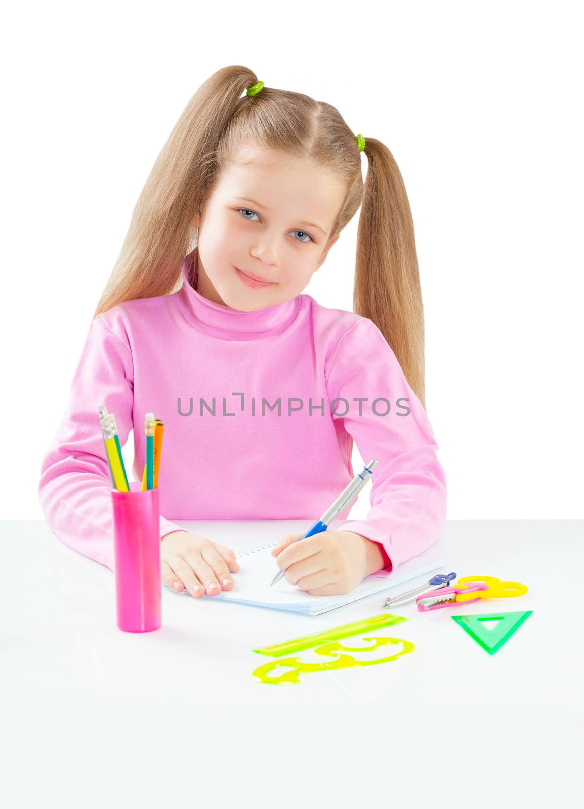 litli girl sitting at table and writing with ballpoint pen isolated