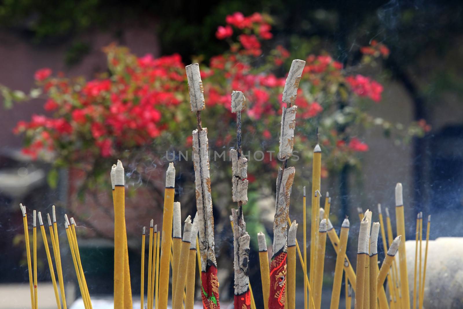 Burning incense sticks in stone bowl in Hong Kong