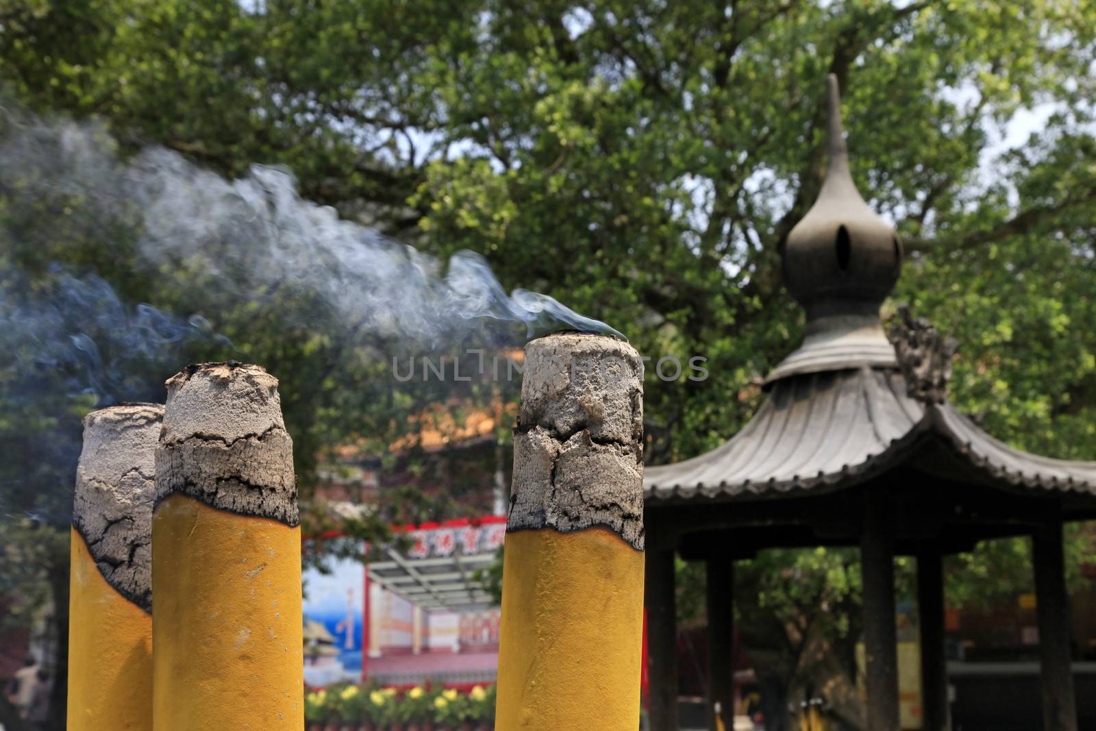 Burning incense sticks in stone bowl in Hong Kong