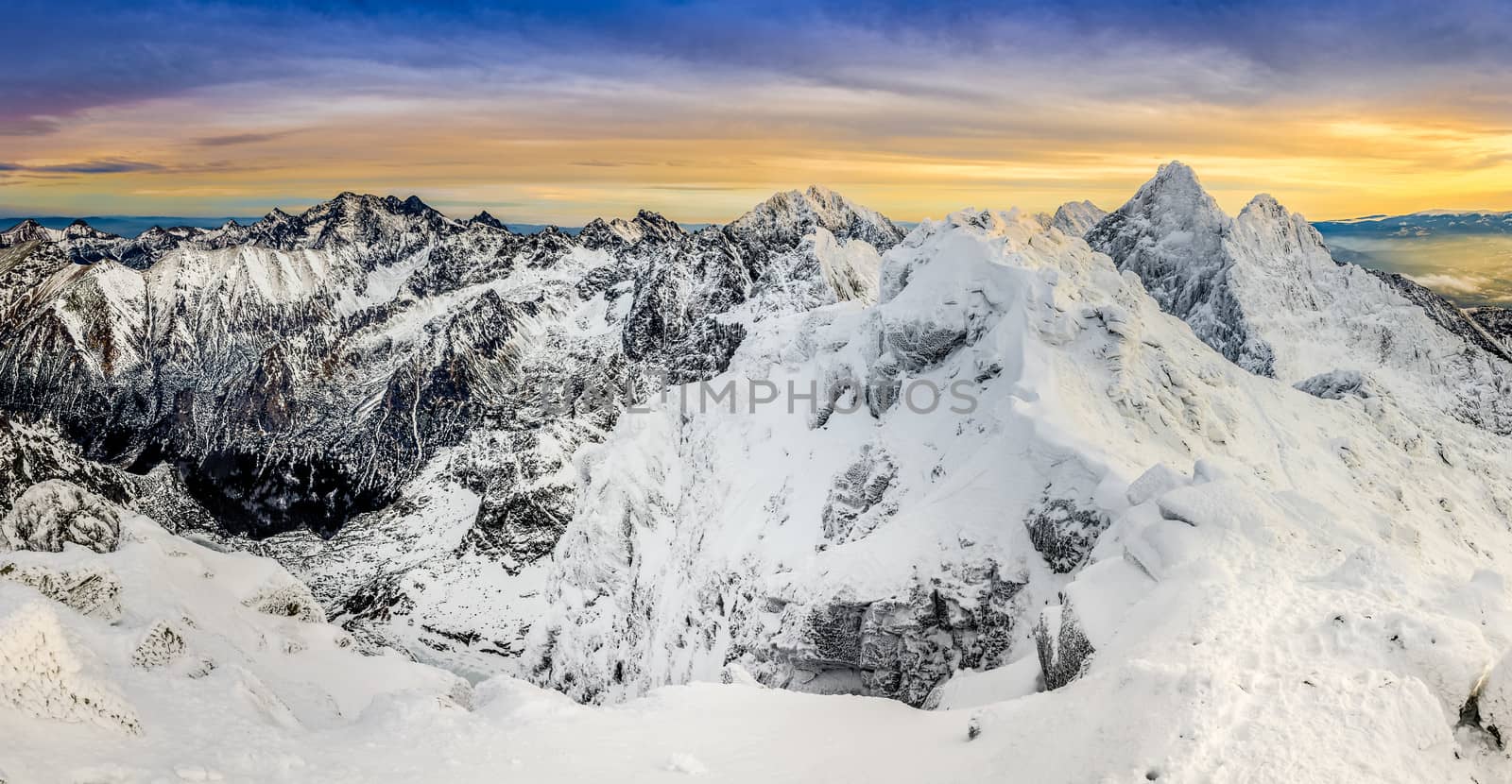 Panoramic view of winter mountains at colorful sunset, High Tatras, Slovakia