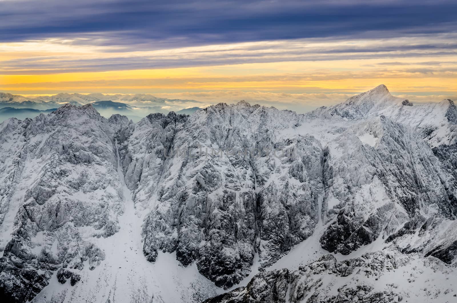 Scenic view of white winter mountains with colorful sunset, High Tatras, Slovakia