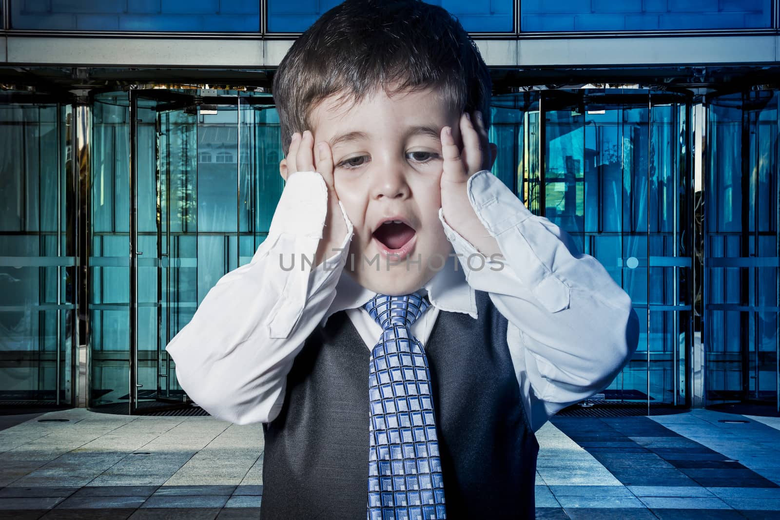 Expression, child dressed businessman with hands in his tie and by FernandoCortes
