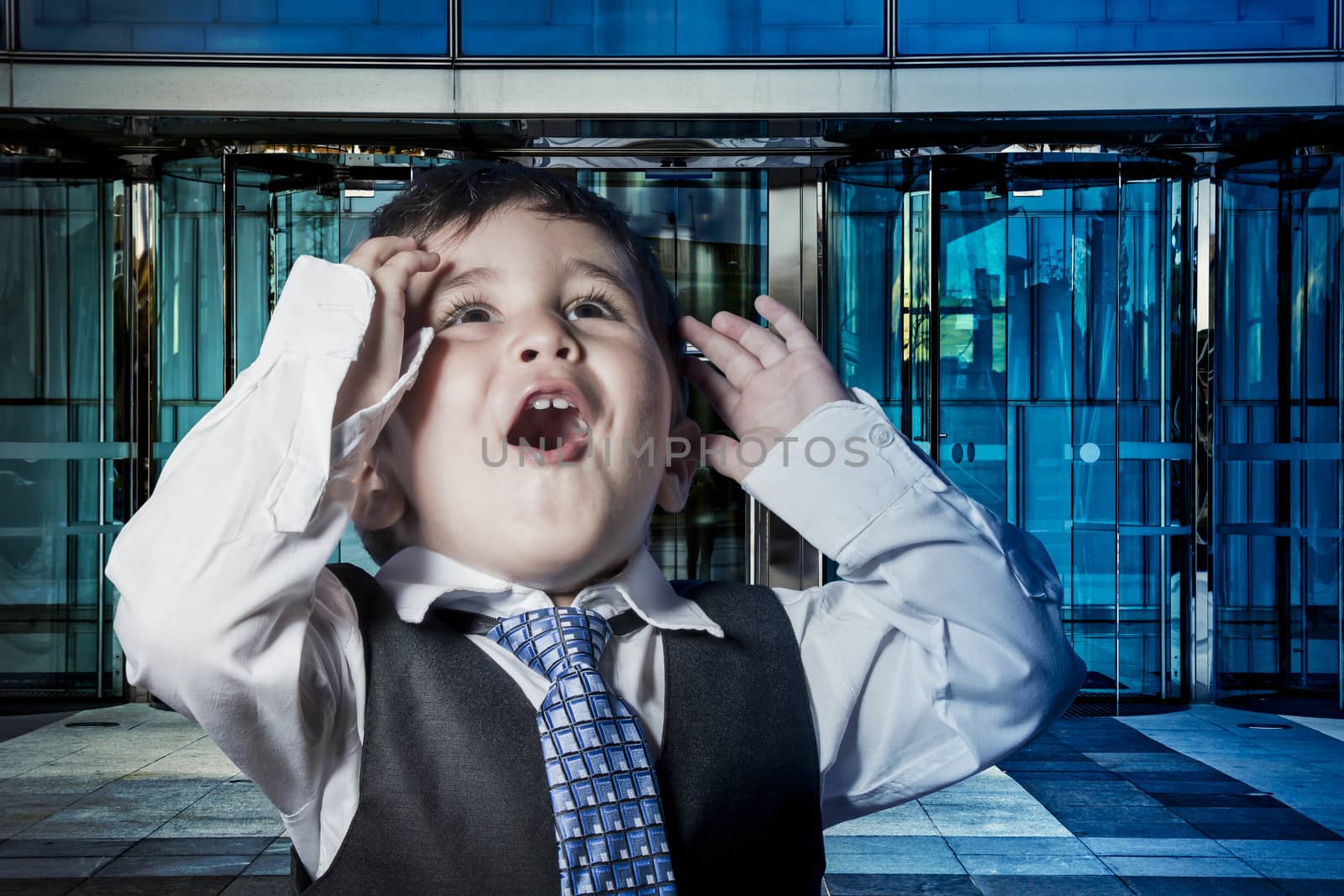 Office, child dressed businessman with hands in his tie and skys by FernandoCortes