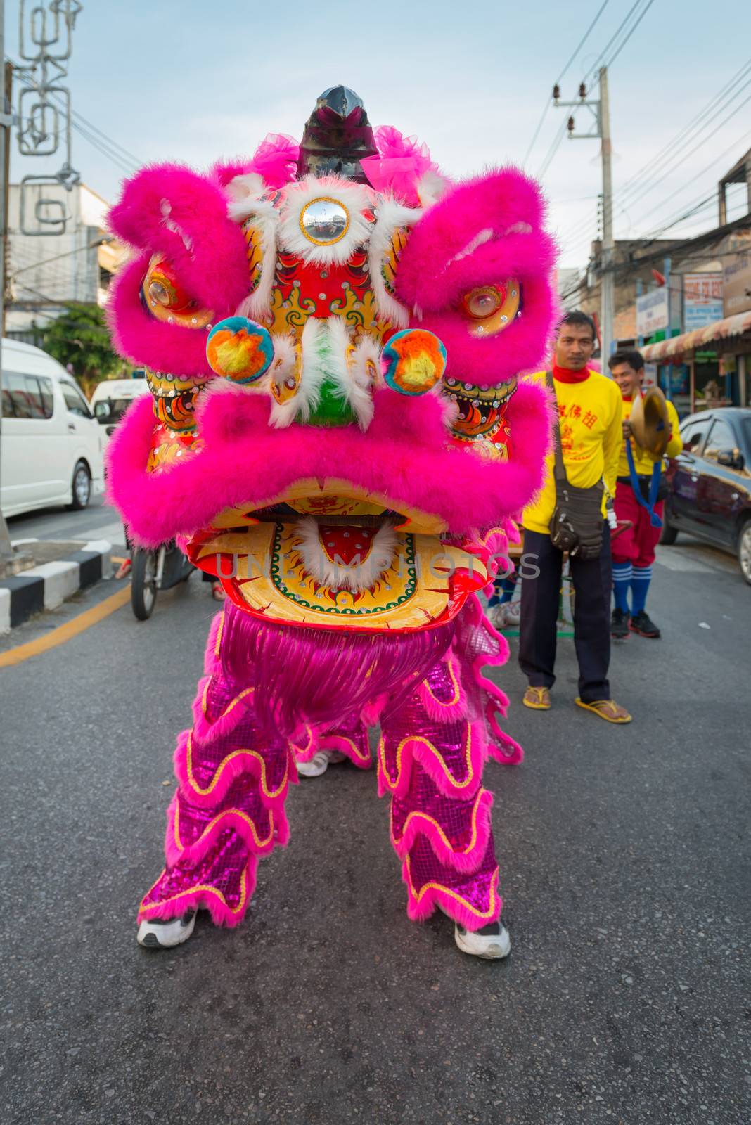 PHUKET, THAILAND - 07 FEB 2014: Dragon image in bright costume take part in procession parade of annual old Phuket town festival. 
