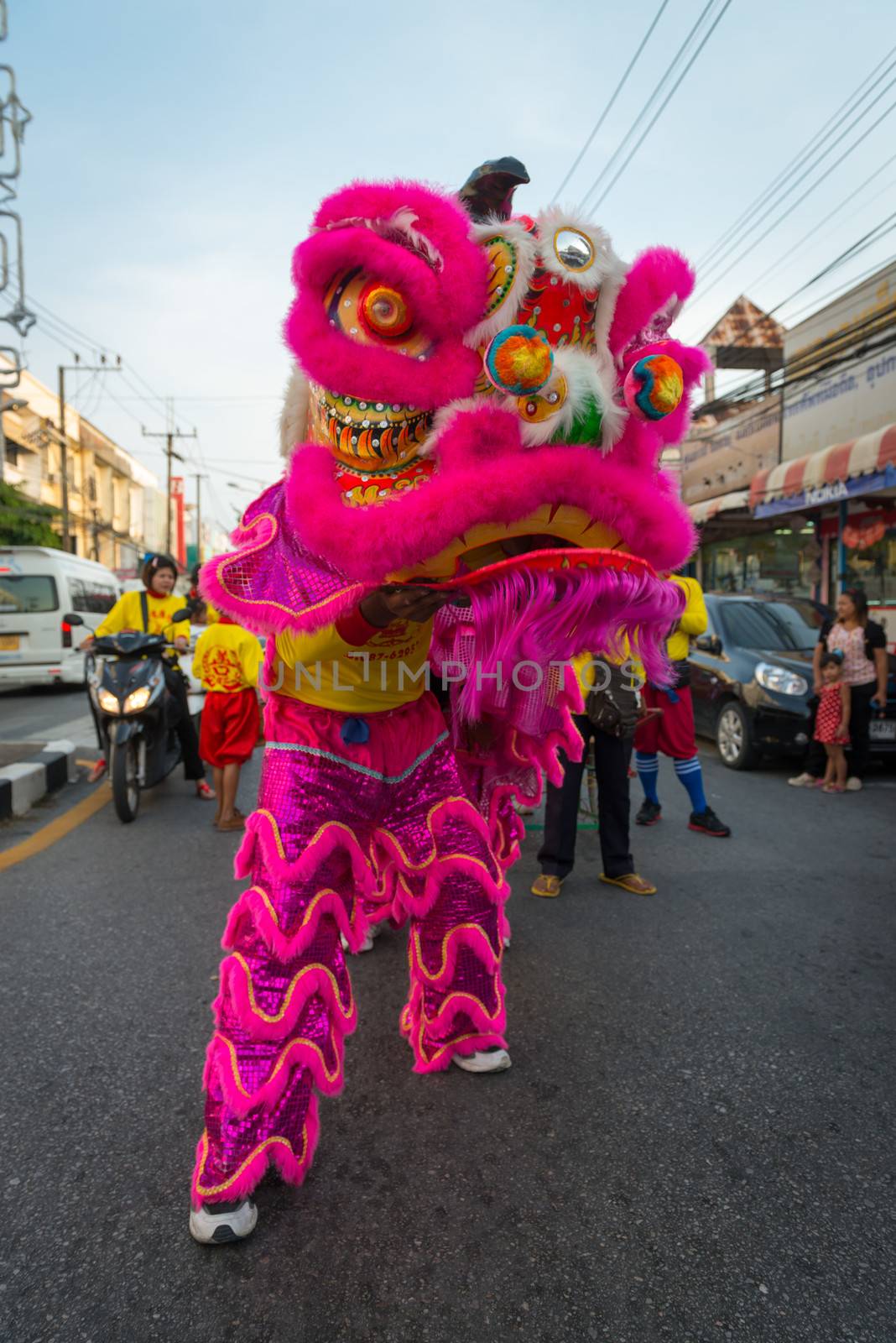 PHUKET, THAILAND - 07 FEB 2014: Dragon image in bright costume take part in procession parade of annual old Phuket town festival. 
