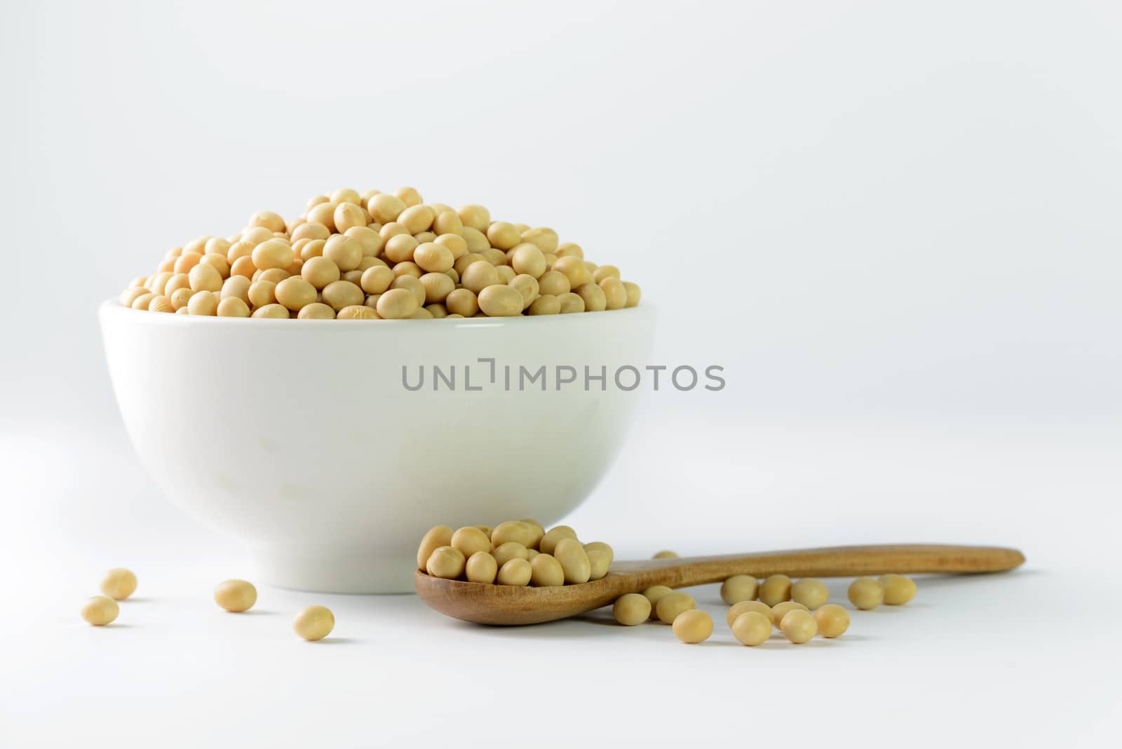 Heap of soya beans on bowl on white background