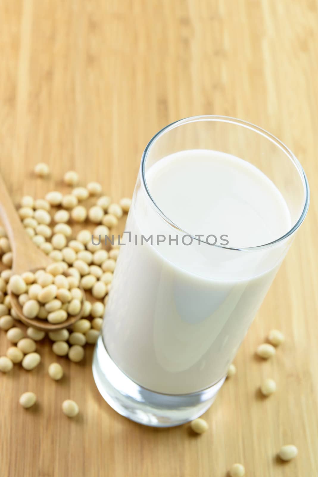 Soymilk and soy beans on wooden chopboard