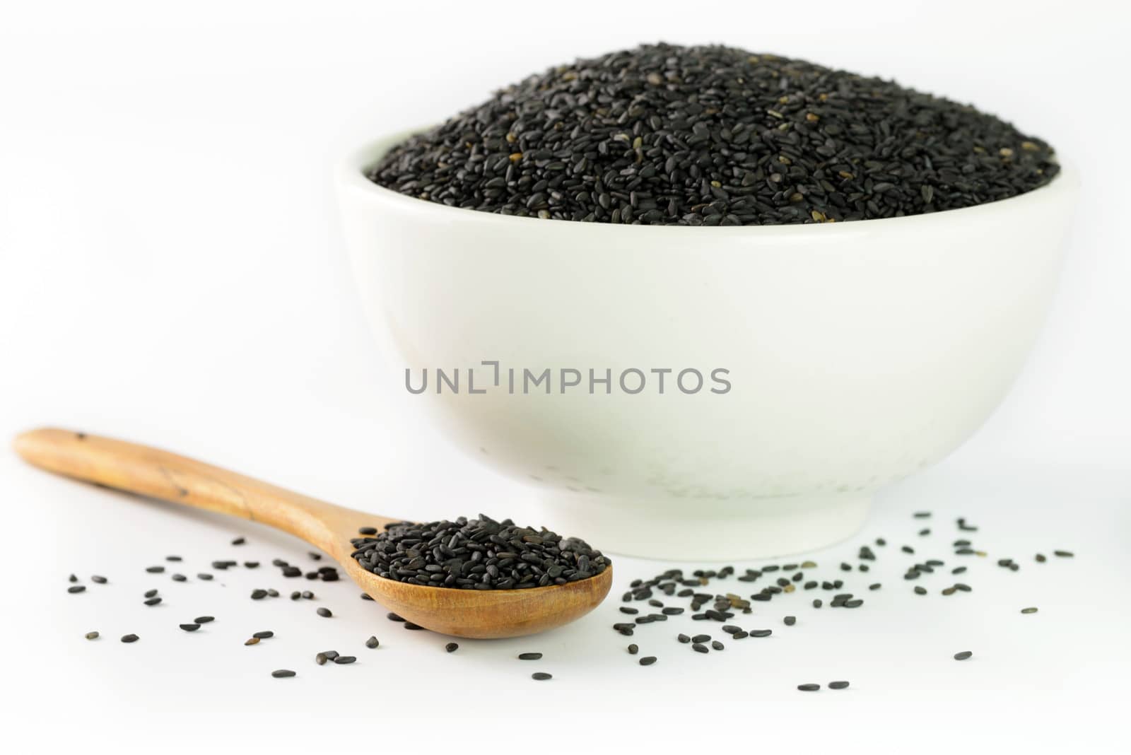 Close up of black sesame in bowl and wooden spoon