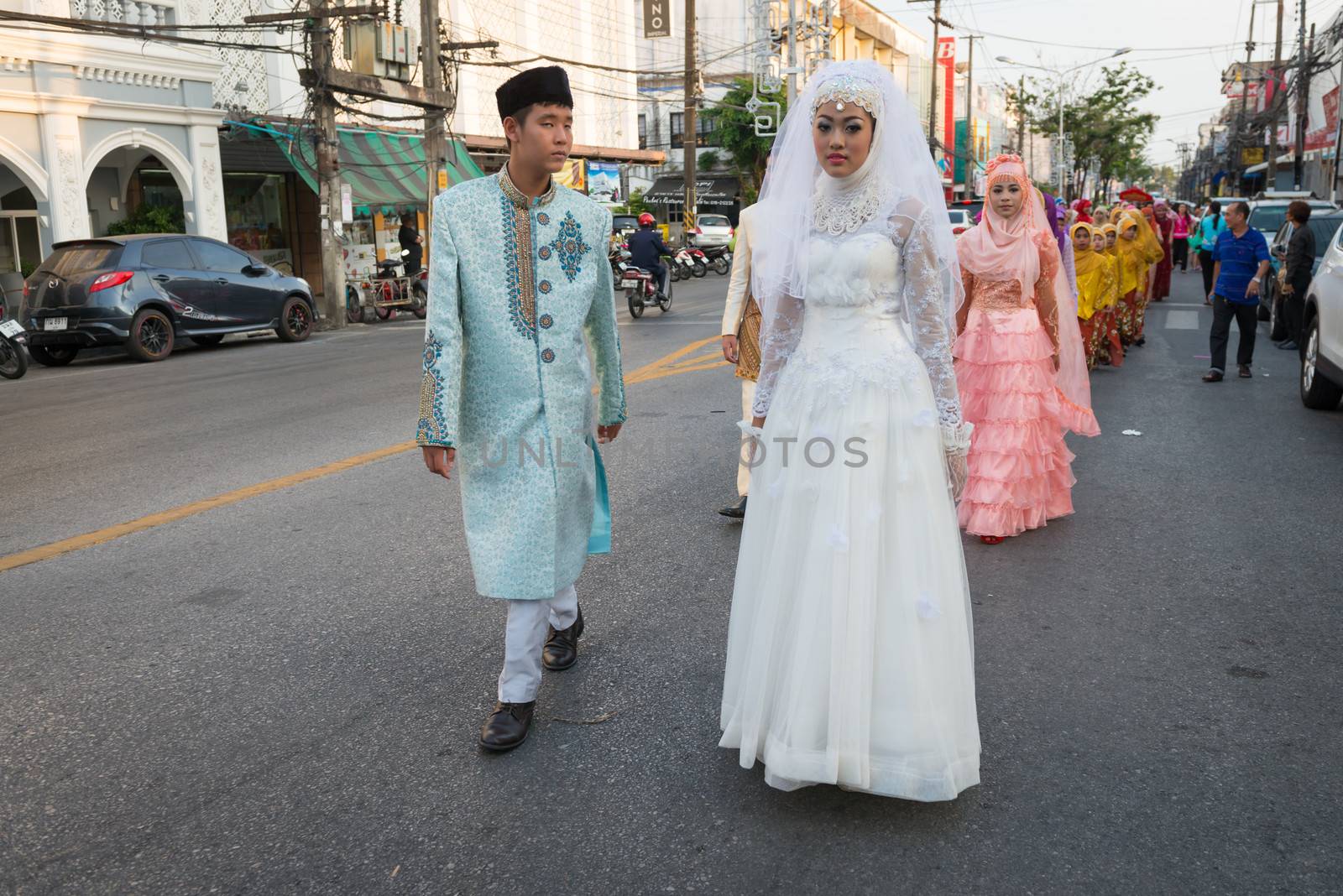 PHUKET, THAILAND - 07 FEB 2014: Phuket town residents in wedding dress take part in procession parade of annual old Phuket town festival. 