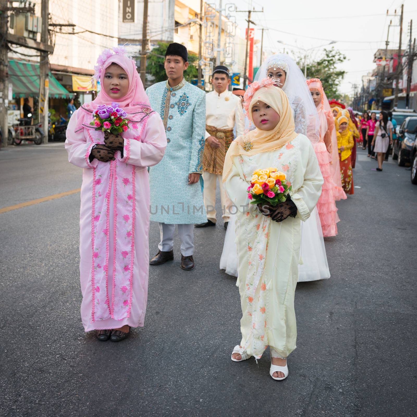 PHUKET, THAILAND - 07 FEB 2014: Phuket town residents  in wedding dress take part in procession parade of annual old Phuket town festival. 
