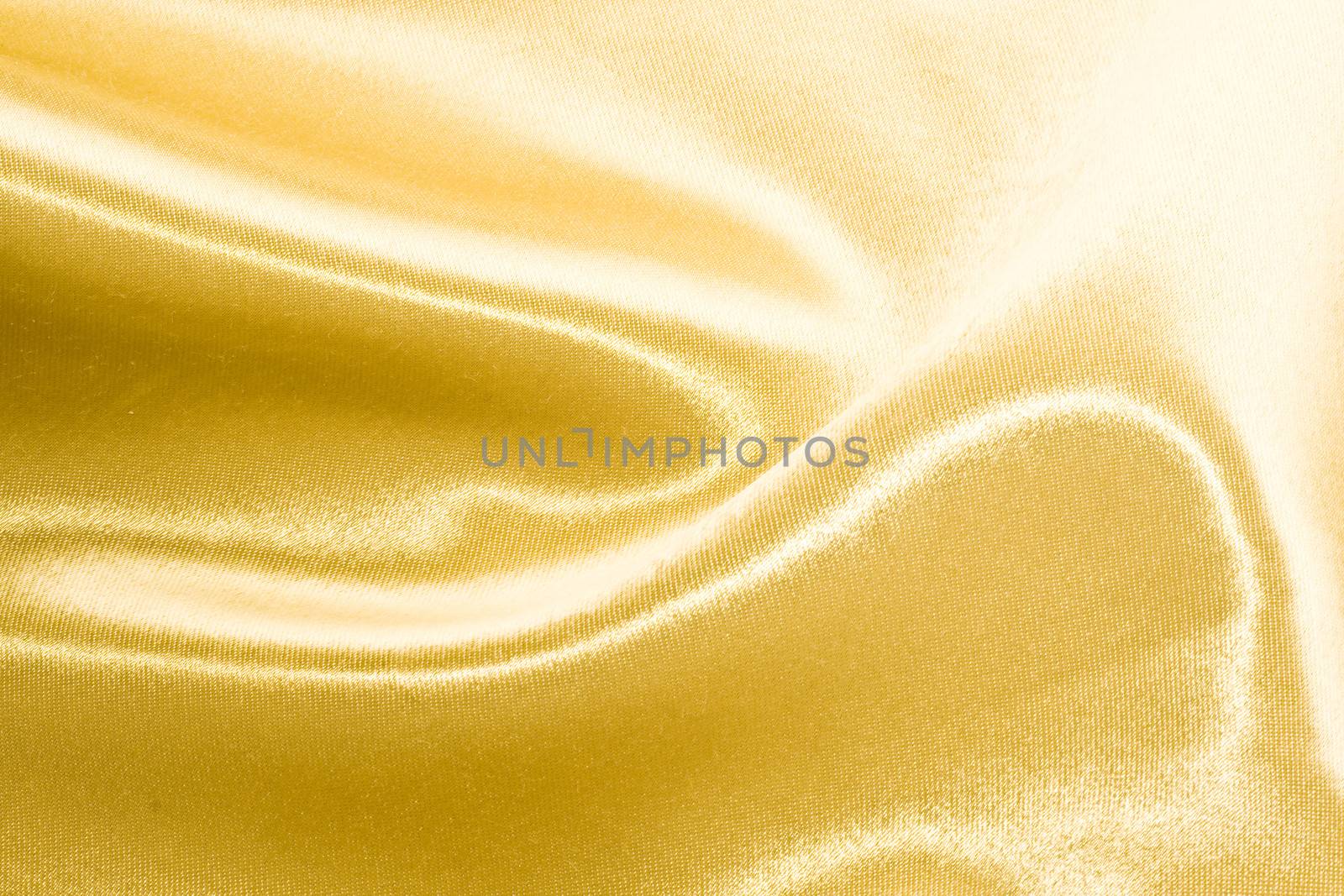 Golden satin or silk background with beautiful waves