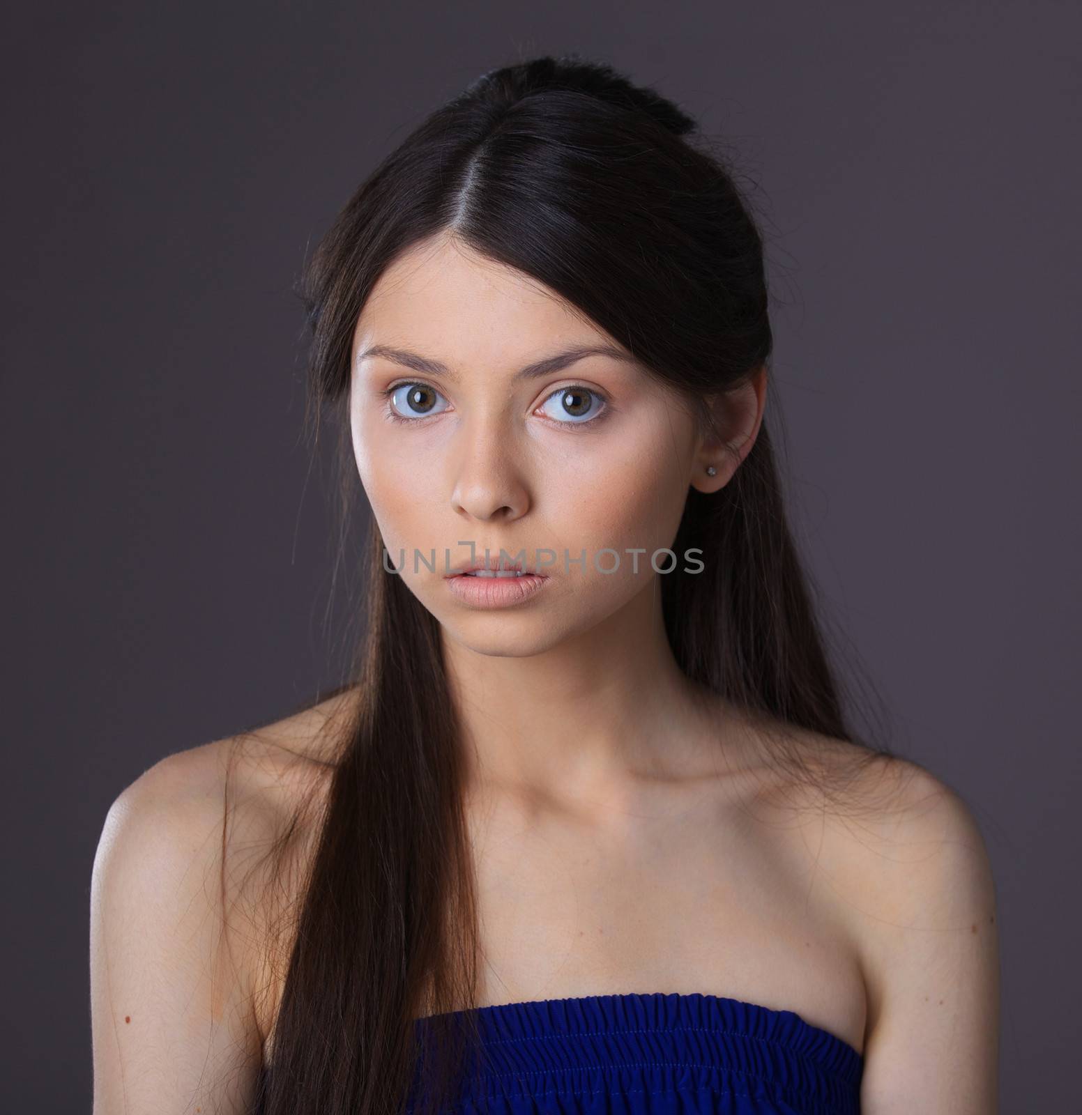 Clouse-up glamour portrait of beautiful woman model with fresh daily makeup and romantic hairstyle.