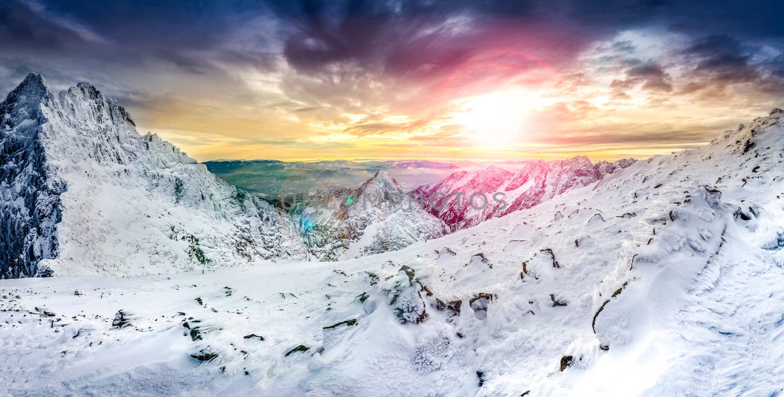 Panoramic view of white winter mountains at colorful sunset, High Tatras, Slovakia