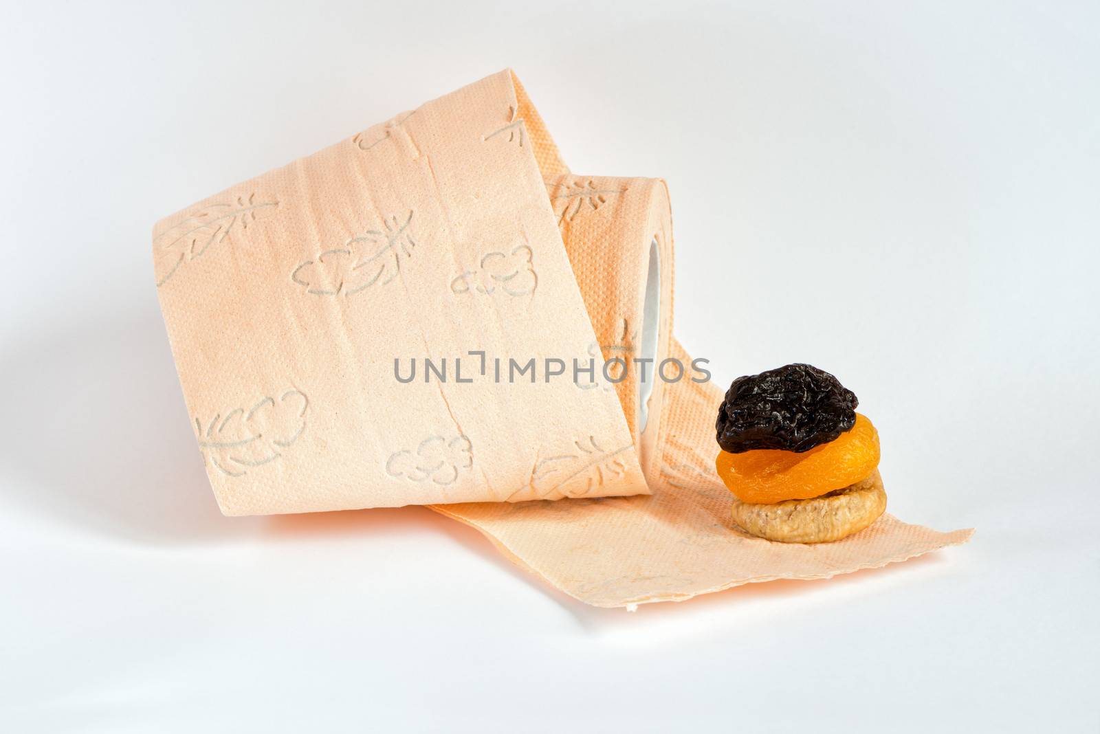 Prunes, dried apricots, fig and roll of pink toilet paper