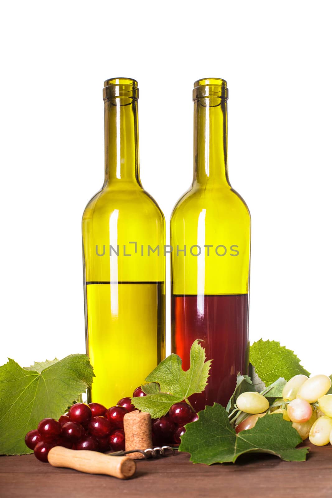 Red and white wine in bottles on the wooden table