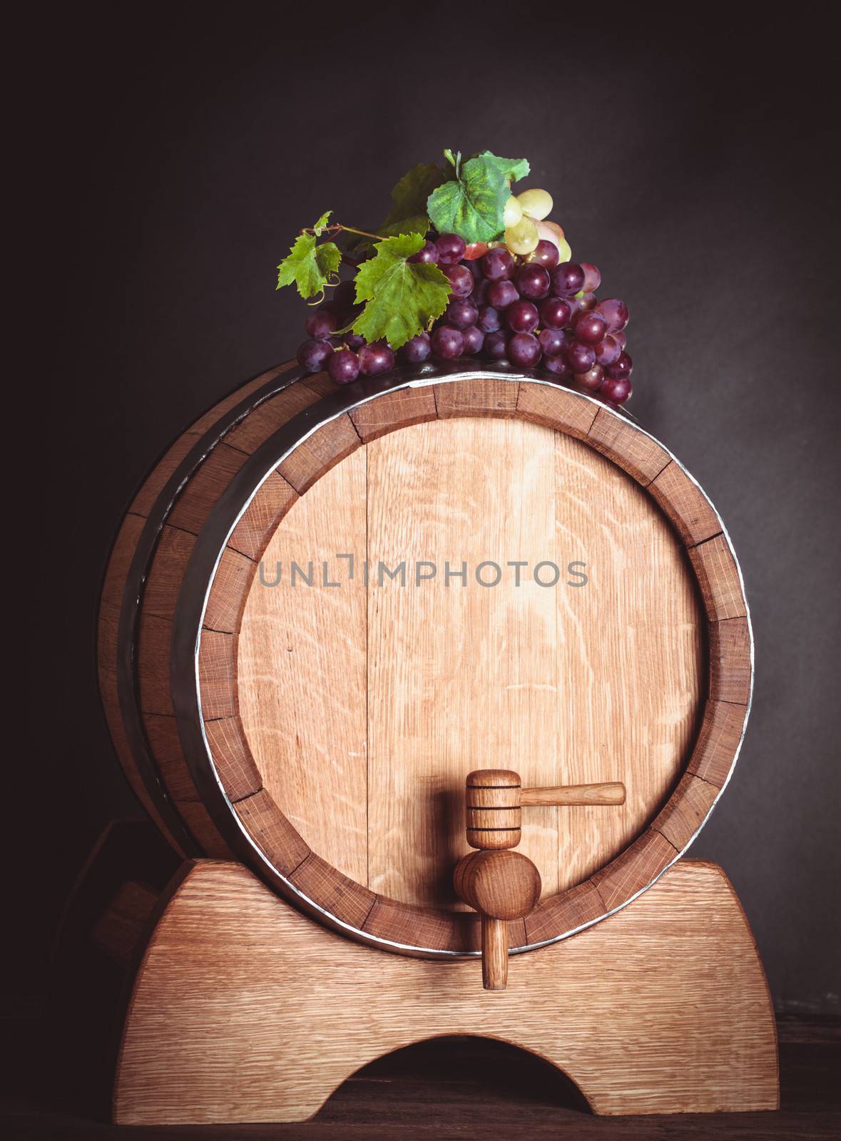 Grapes on wooden barrel by oksix