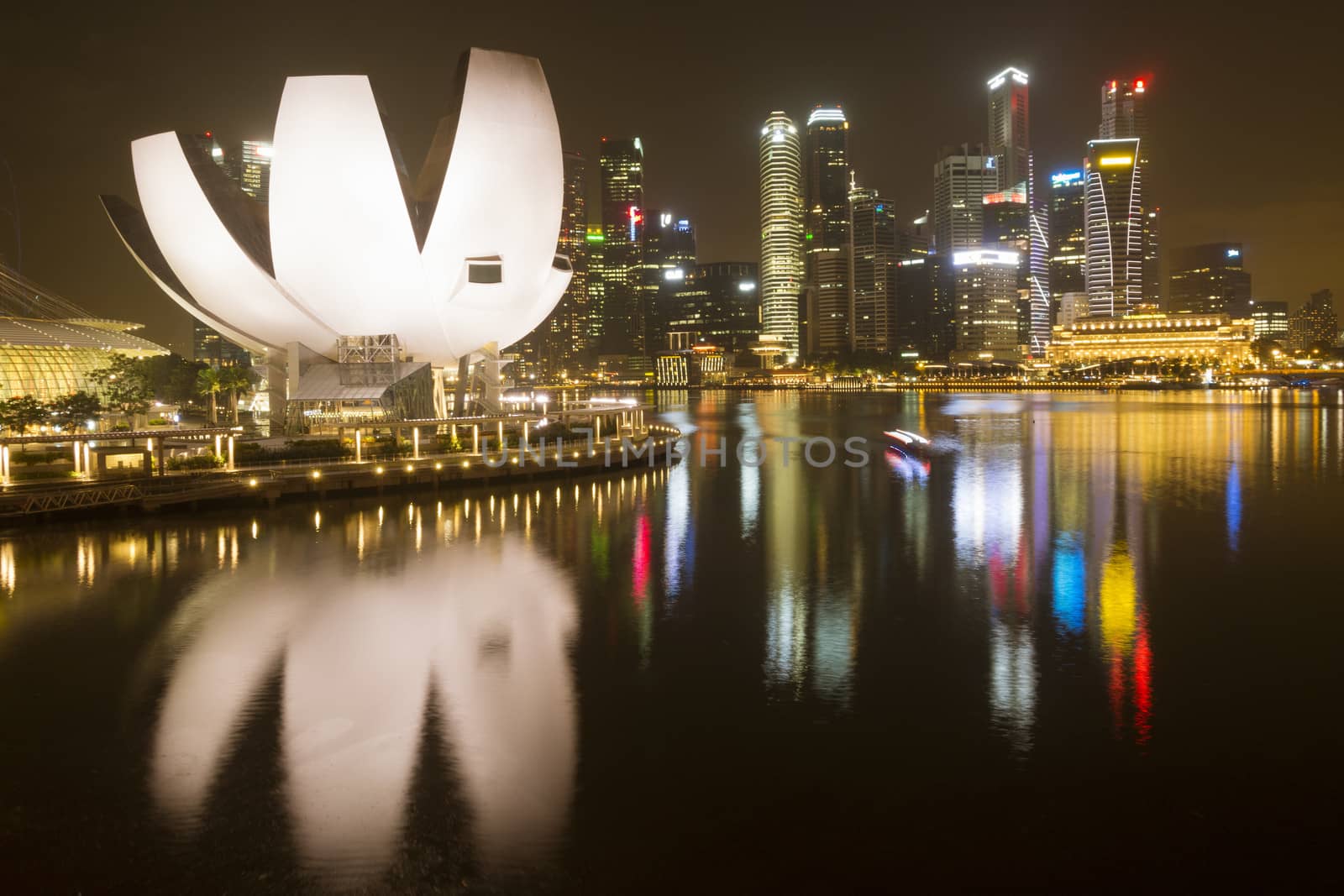 Singapore - January 12,  2013: downtown skyline by night with scenic building of Singapore Art Science museum on foreground.