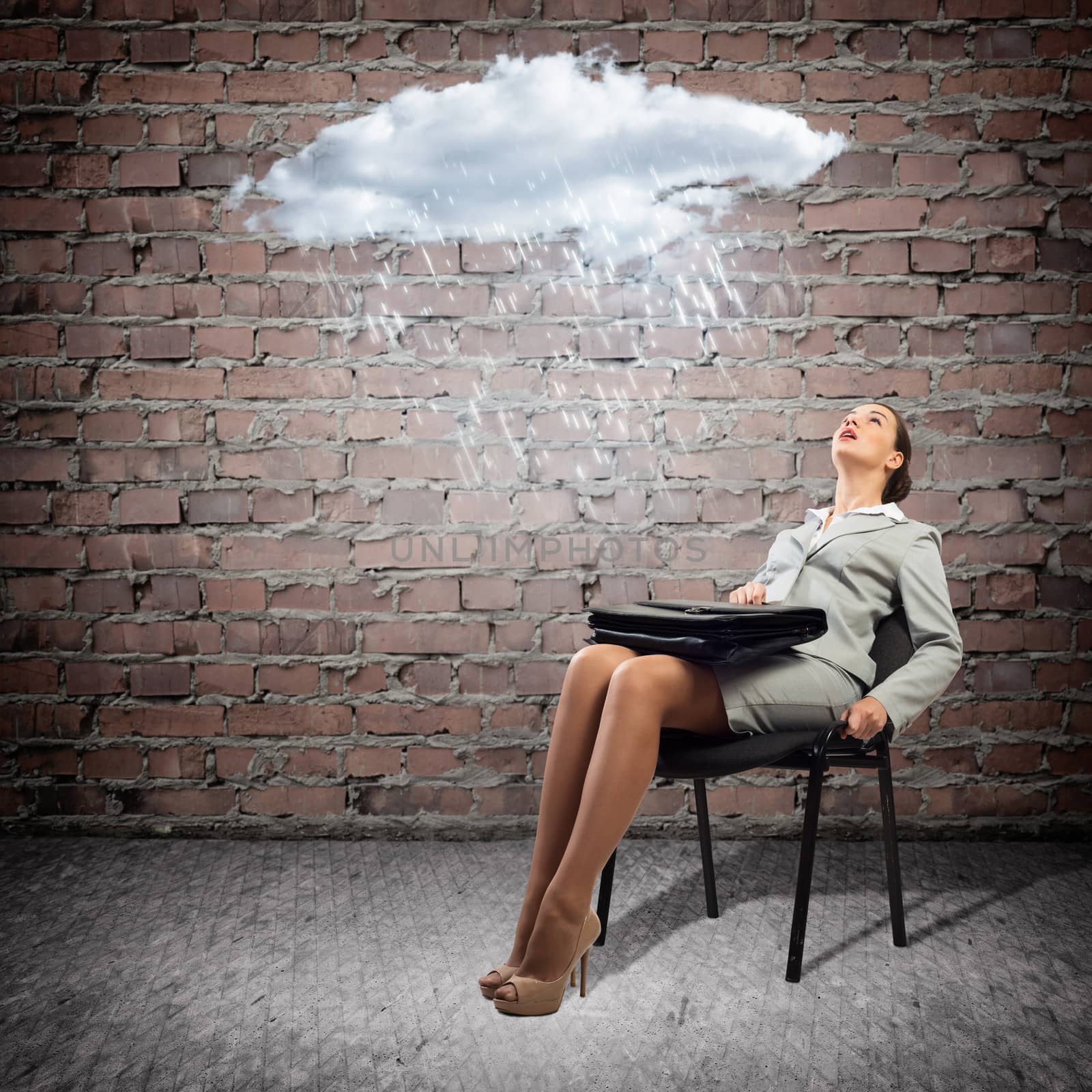 image of a young business woman looking at the cloud with lightning