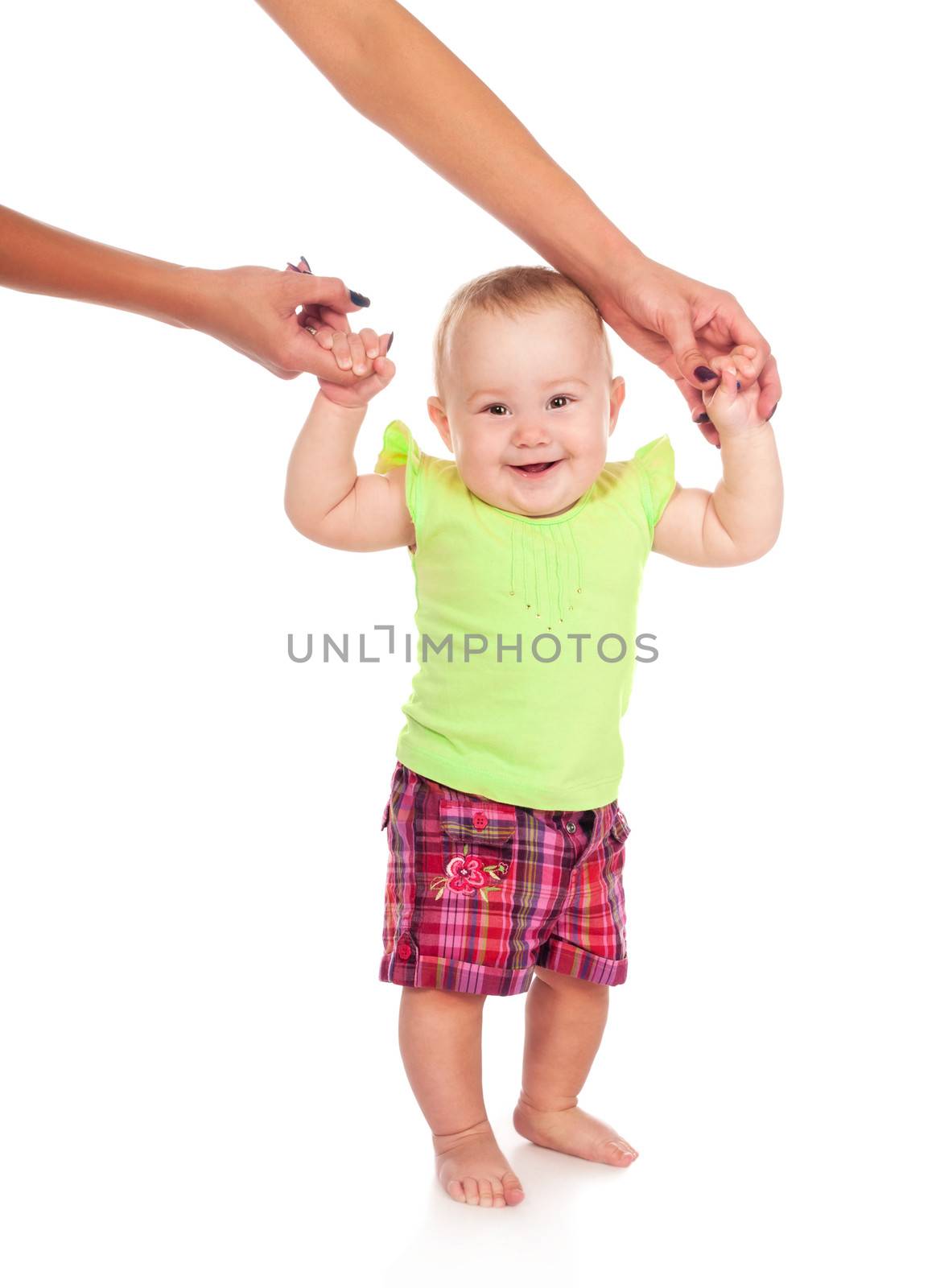 Smiling child walking hand in hand with mom. Isolated on white